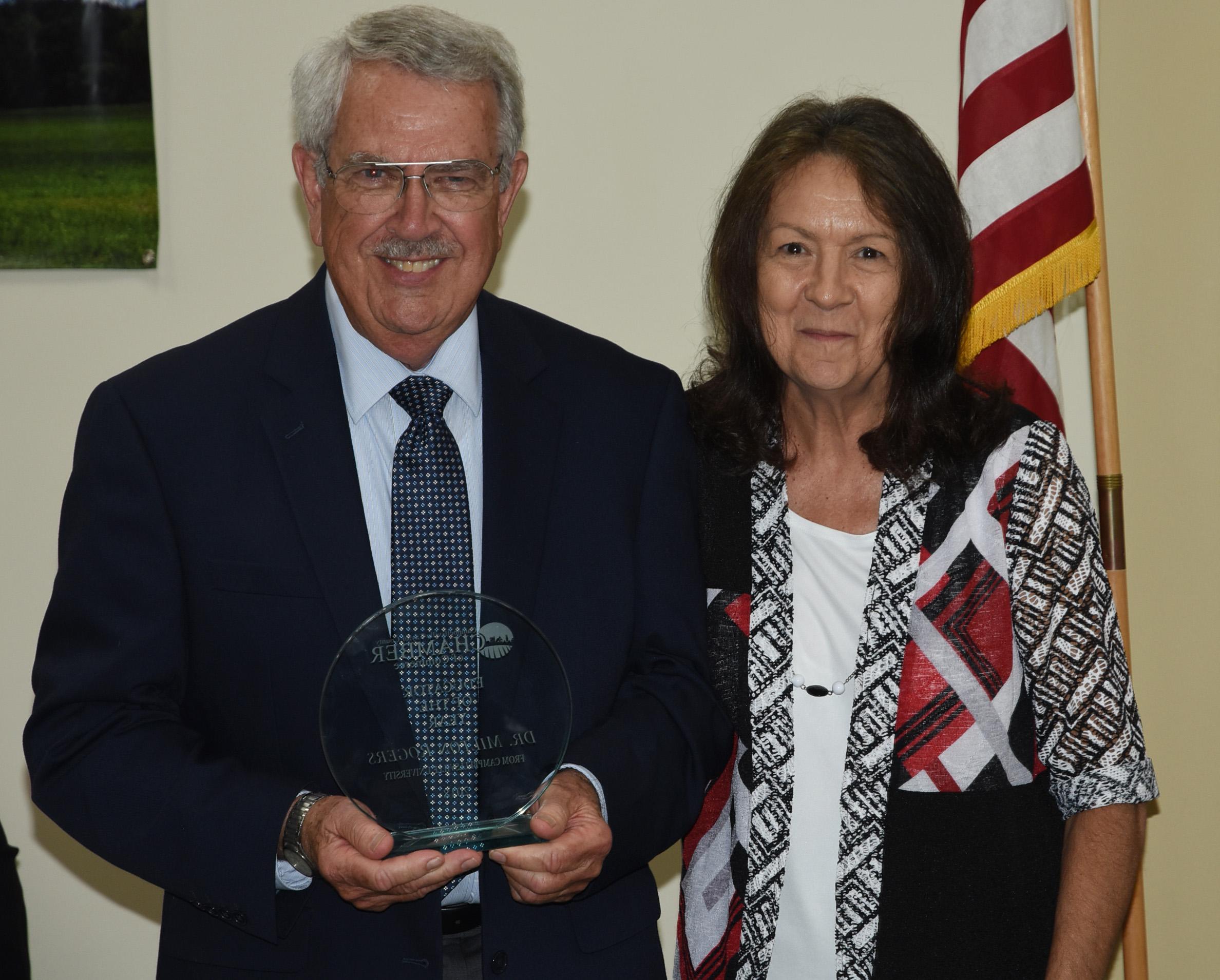 Dr. Milton Rogers, right, receives the Campbellsville-Taylor County Chamber of Commerce Educator of the Year Award from Dr. Pat Cowherd, president of the chamber who is dean of the School of Business, Economics and Technology at CU. (CU Photo by Joan C. McKinney)