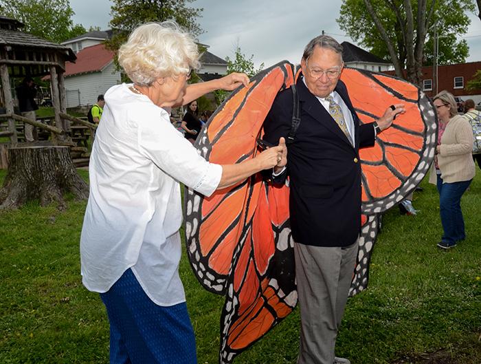 Susie Walters, on right, helps George Howell, to put on the butterfly wings at the Earth Day ceremony at Campbellsville University. ((Campbellsville University Photo by Tomomi Sato) 