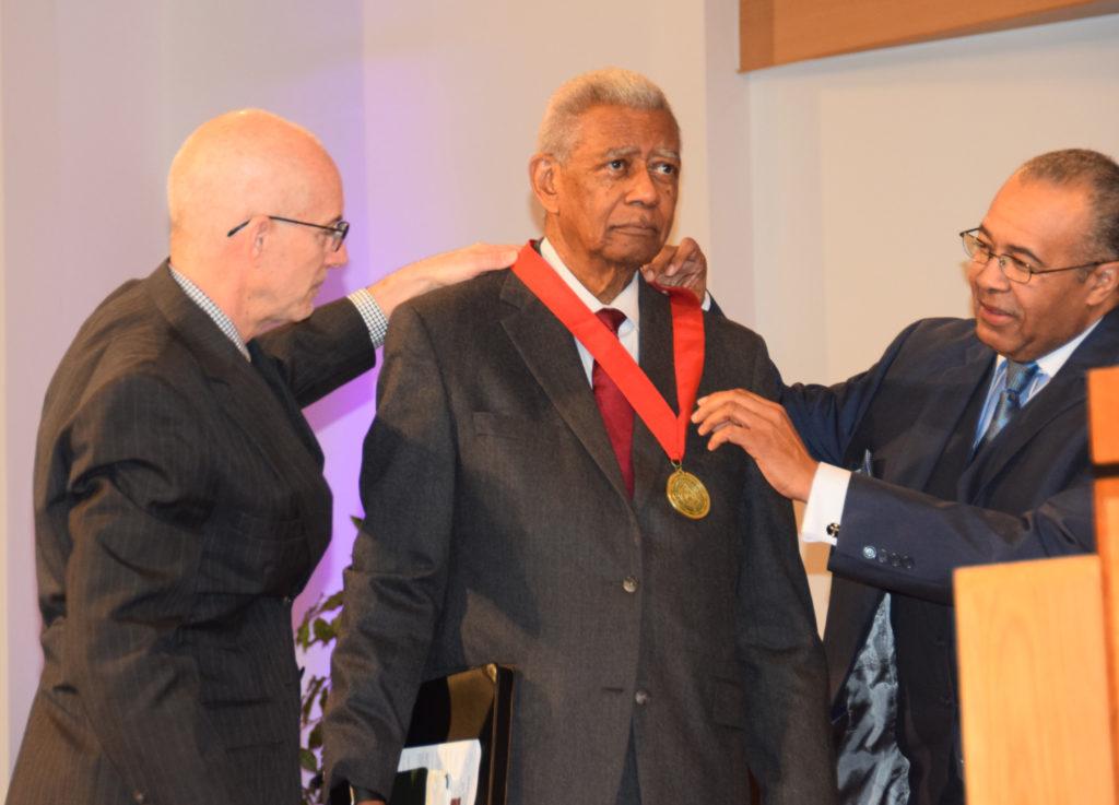 Dr. Joseph Owens, left, a member of the Campbellsville University Board of Trustees, and Dr. John Hurtgen, dean of the CU School of Theology, places the Campbellsville University Leadership Award on Dr. Otis Moss Jr. (CU Photo by Luke Young)